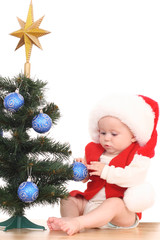 baby girl and Christmas tree