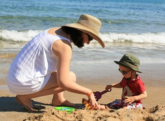 Mom and kid playing in the sand