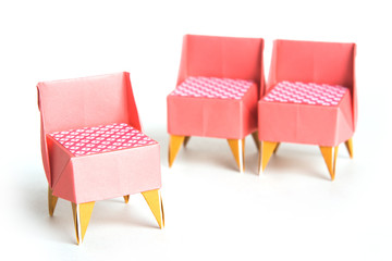 Three origami chairs on a white background