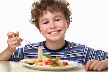 Boy eating pasta