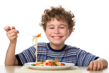Boy eating pasta