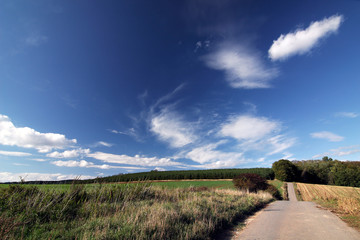 Road and blue sky with clouds