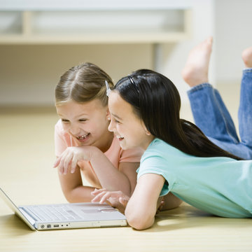 Young Girls playing on a Laptop Computer