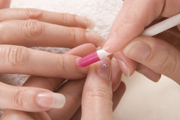 Manicurist preparing cuticles for manicure