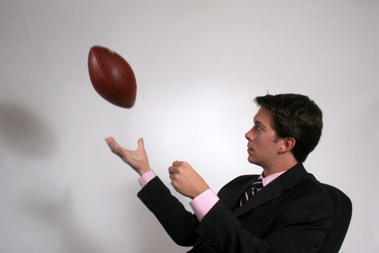 Business Man Tossing Football