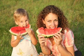 mother and daughter eating watermelone