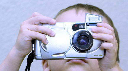 young boy using digital camera