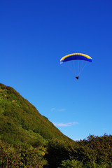 Parasailing next to a mountain