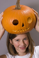 beautiful girl holding pumpkin