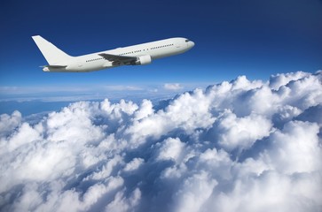 Large airliner along clouds - obrazy, fototapety, plakaty