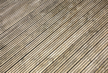 Fototapeta premium Grooved wooden garden decking close up.