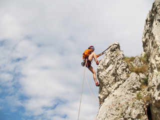 rapelling down a rock