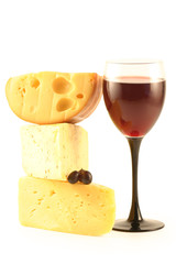 Grapes, cheese and a glass with red wine isolated on white.