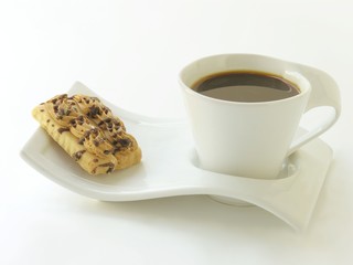 cup of coffee with tasty small crisp cake