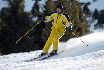 Yellow skier on ski slope