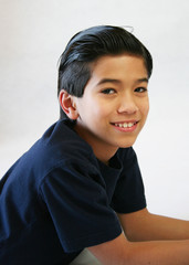 Handsome young boy lying down looking towards camera