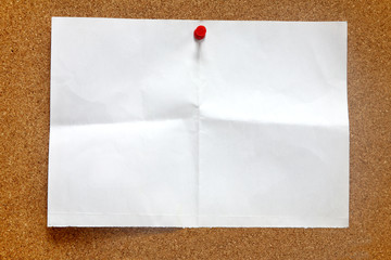 An old piece of paper on a notice board.