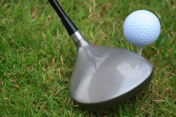 Driver and golf ball on a tee peg