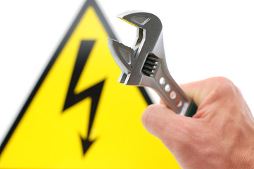high voltage sign and spanner