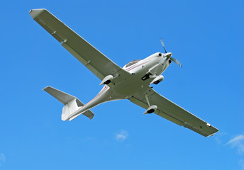 Bottom view of light hobby aircraft in flight