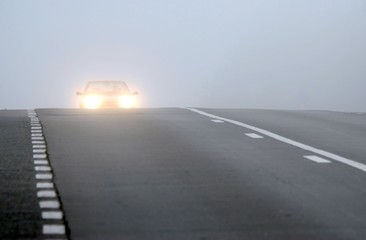 Car appearing through fog