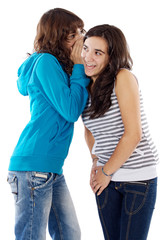 Teenager girls whispering a secret