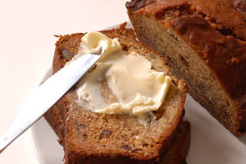 Banana walnut bread with a knife and butter