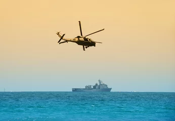 Fotobehang helicopter hovering over battleship © icholakov