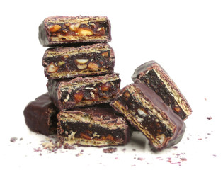 Pile of broken chocolate with nuts and strawberry jam filling