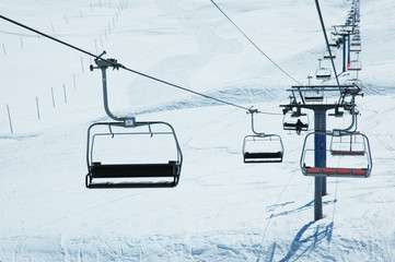 Ski lift chairs on bright winter day