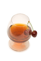 Glass of wine and cherry isolated on white