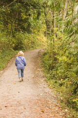 Fototapeta na wymiar Woman Walking Through Woods