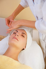 Fototapeta na wymiar Facial cryogenic massage in spa salon