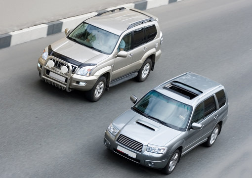 Fototapeta two suv cars on road part of "luxury cars" series
