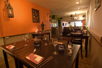 tables inside eastern orange atmosphered mediterran restaurant
