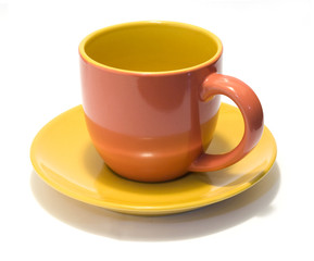 glazed pottery coffee cup and saucer with white background 