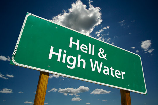 "Hell & High Water" Road Sign with dramatic blue sky and clouds.
