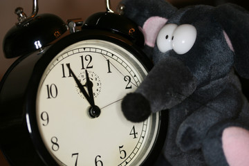 toy mouse and clock in eve of new year