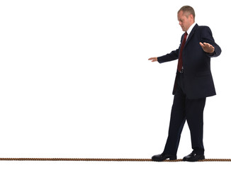 Businessman walking a tightrope