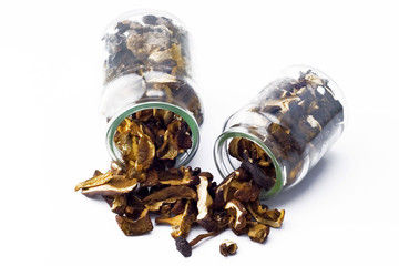 Two glass containers of dried mushrooms