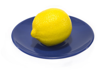 Fresh Lemon on a blue plate isolated on white background