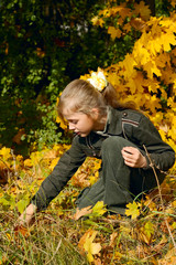 young blond girl in an autumn park