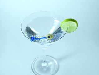 Martini in glass with lime and olive