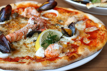 seafood pizza - lobster or langouste, mussels, prawns, squid rin