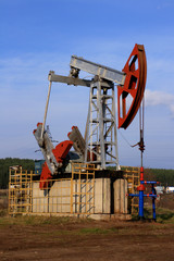 Fototapeta na wymiar oil pump extract oil on a background of the blue sky