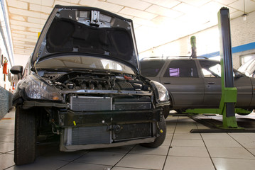 Modern Black Car in a Repair Shop