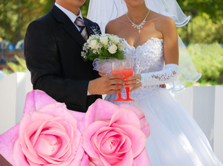 Couple pink roses and just married couple on background