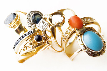 Golden rings with precious stones isolated on white