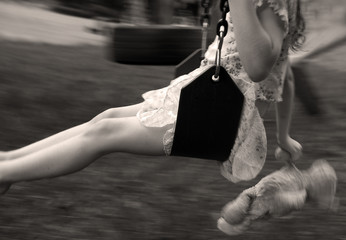 Young Girl Swinging with Bear