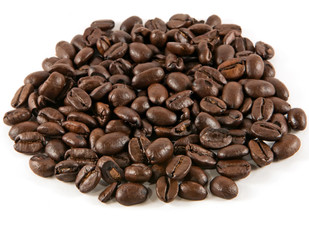 Pile of roasted coffee beans on a white background.